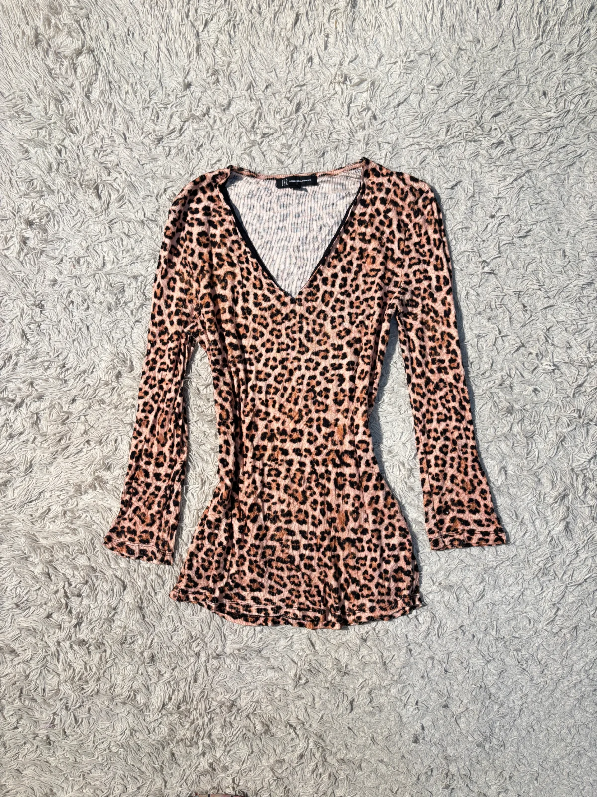 INC International Concepts top features a bold leopard print and a deep v-neckline.